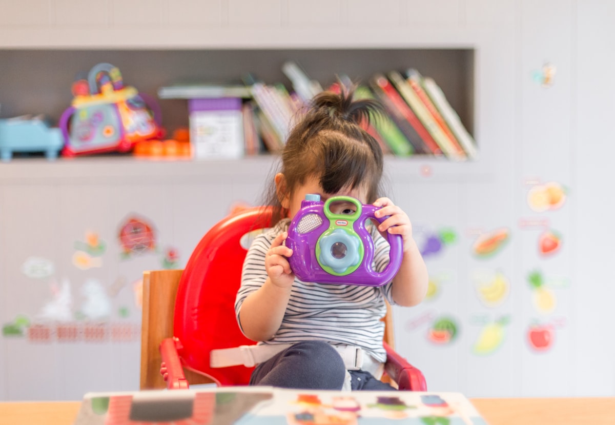 Toddlers exploring wooden toys together