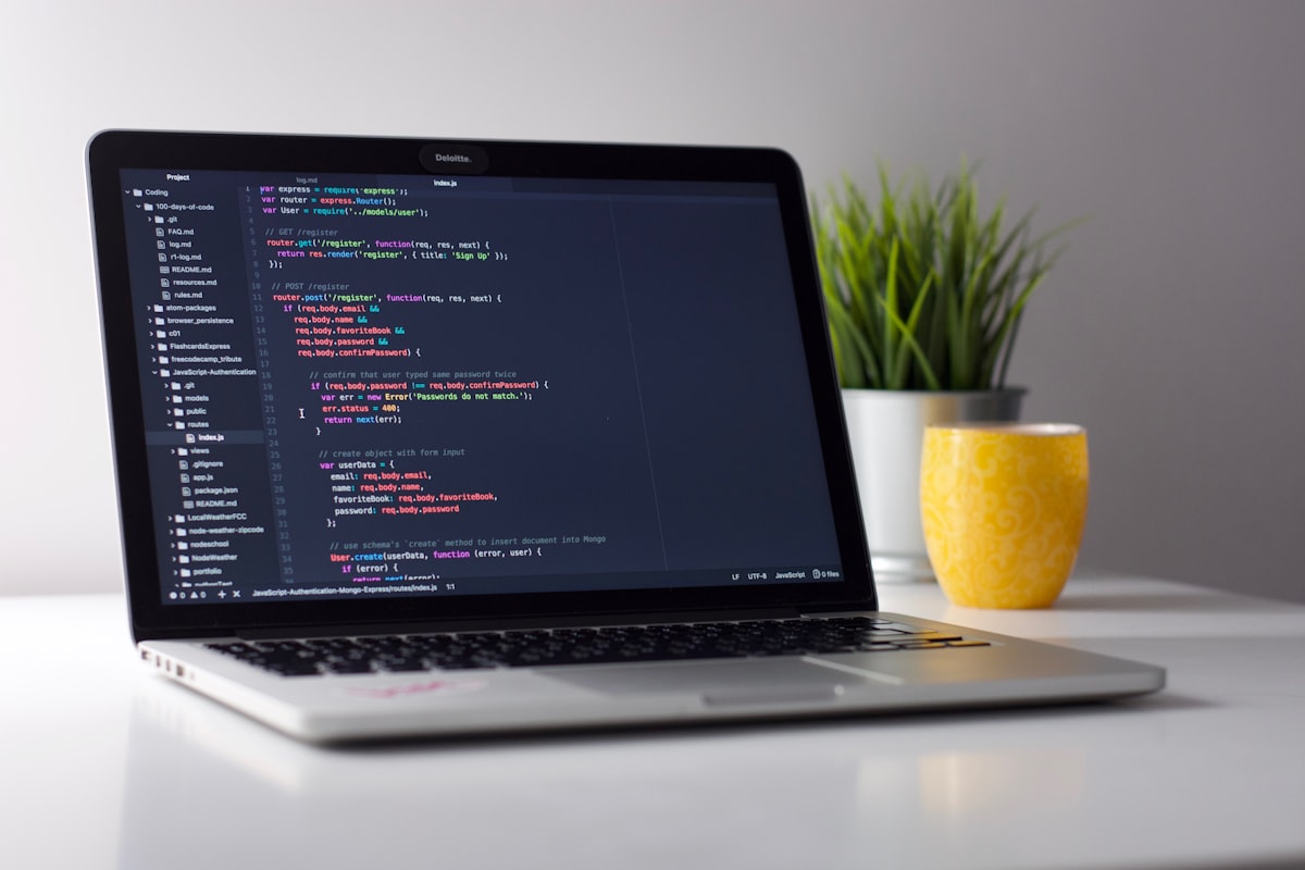 Software engineers collaborating at screens in a technology office