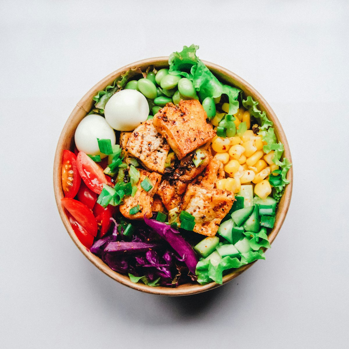 A bright salad with leafy greens and avocado
