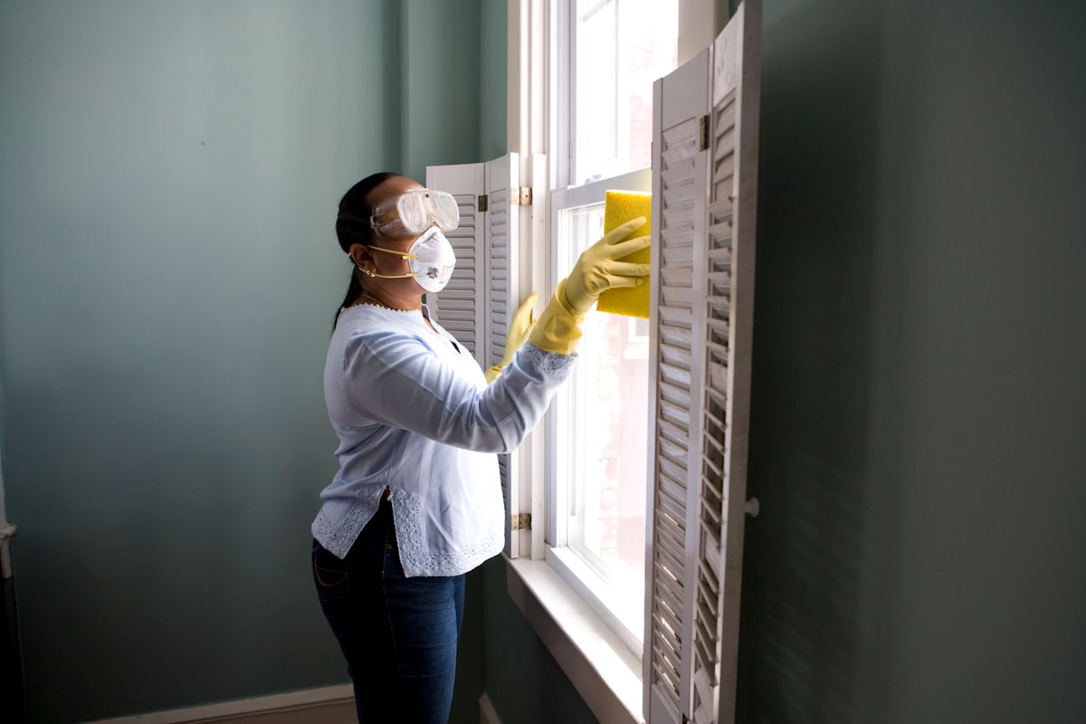 Pest control technician spraying in home